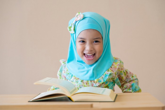 Child Learning Quran from Noorani Quida